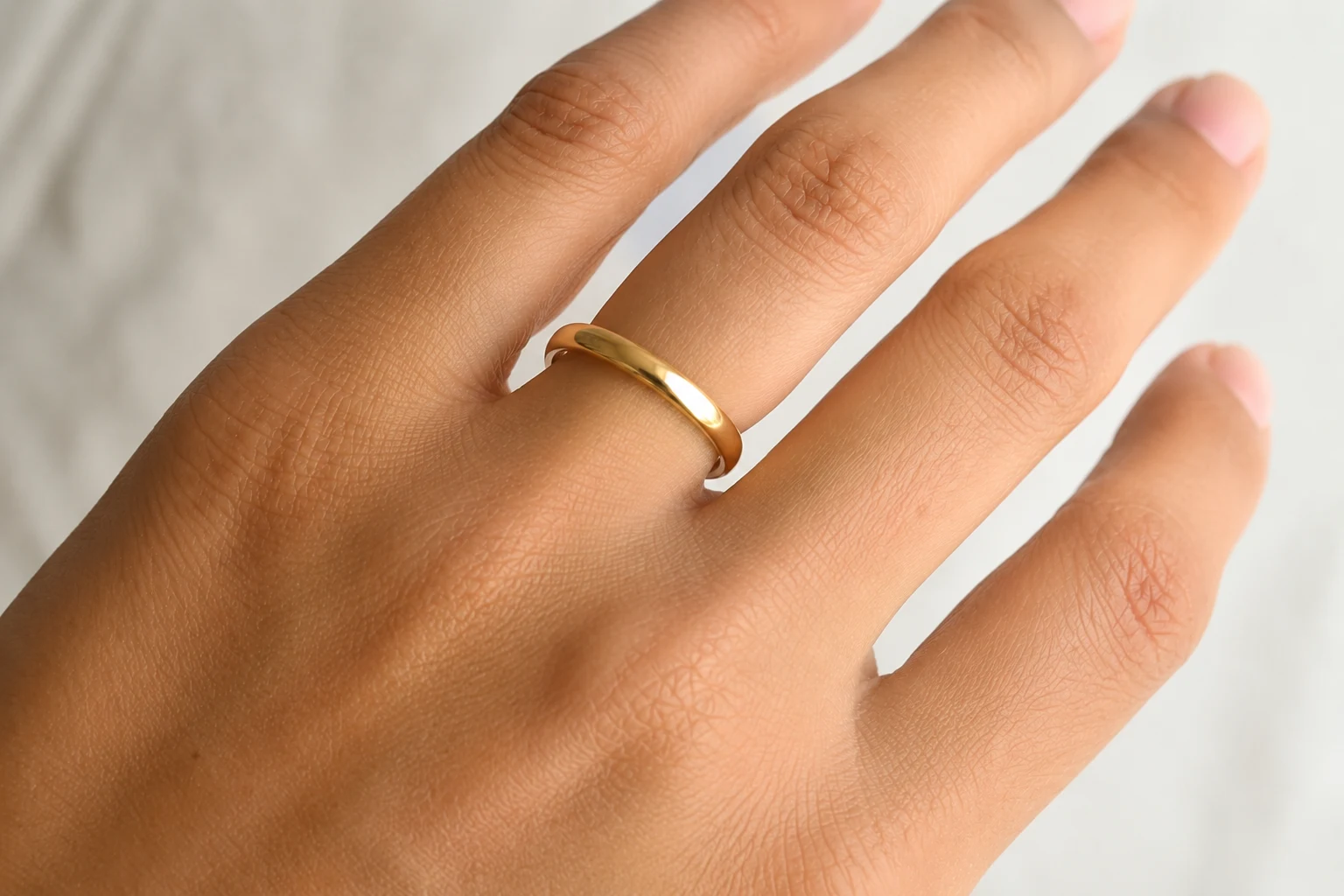 Ring sitting loosely on a finger after weight loss, showing visible space between the band and skin